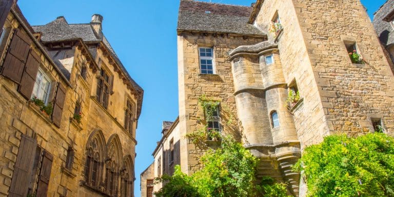 Bâtiments historiques en pierre sous ciel bleu.